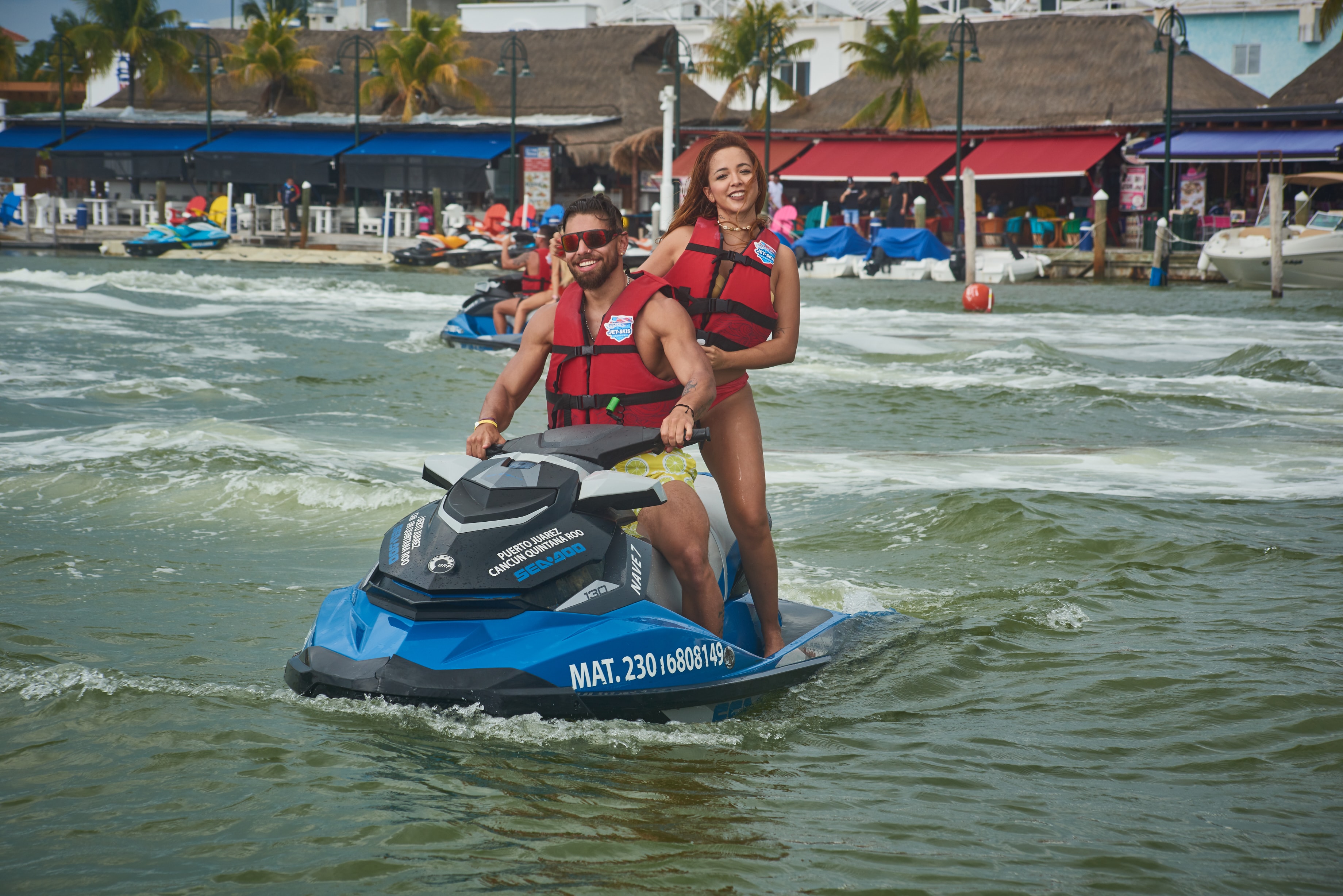 Smiling couple on a Sea-Doo jet ski at the Puerto Juárez marina in Cancun
